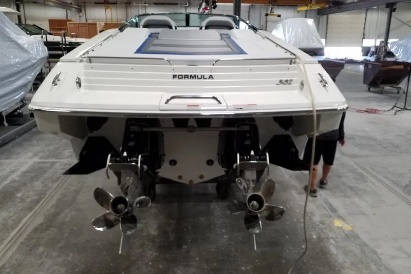 Slide: The Image of 2019 Formula 382 FASTech boat in a workshop, rear view with dual propellers. - 6