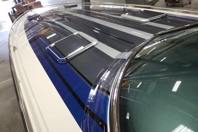 Slide: The Image of 2019 Formula 382 FASTech boat with sleek blue and gray stripes in a showroom. - 8