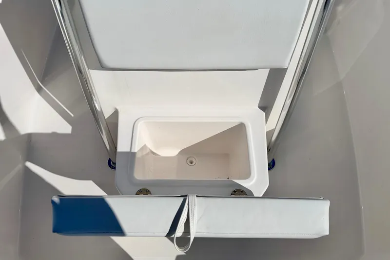 Slide: The Image of 2023 Aquasport 2200 Center Console boat interior with storage compartment. - 10