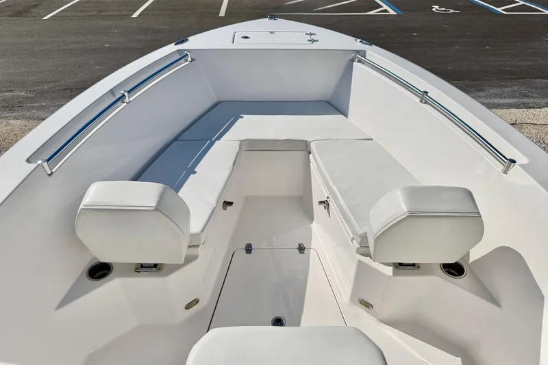 Slide: The Image of 2023 Aquasport 2200 Center Console boat interior with white seating and railings. - 11