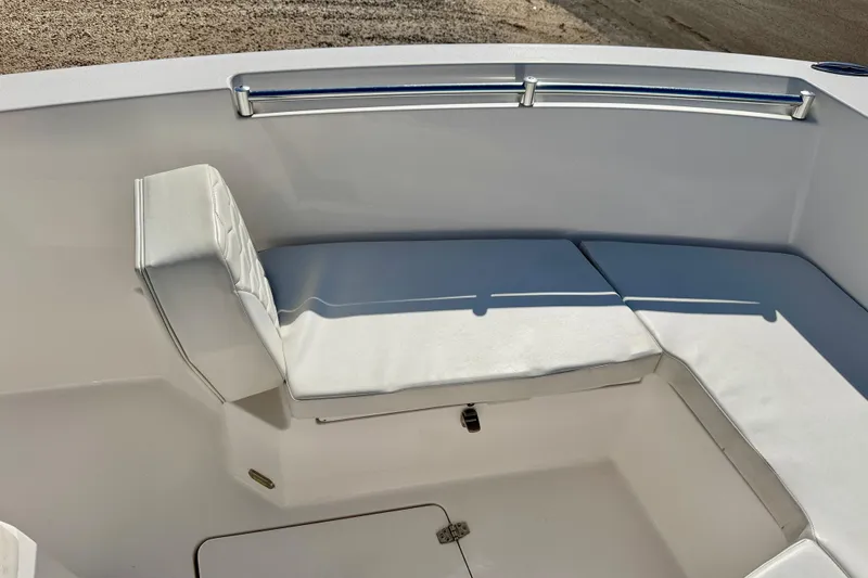 Slide: The Image of 2023 Aquasport 2200 Center Console boat seating area with white cushions. - 13