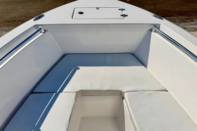 Slide: The Image of 2023 Aquasport 2200 Center Console boat interior with cushioned seating and storage. - 14