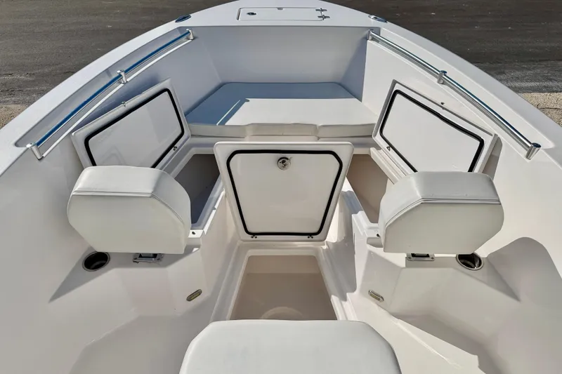Slide: The Image of 2023 Aquasport 2200 Center Console boat interior with storage compartments and seating. - 15