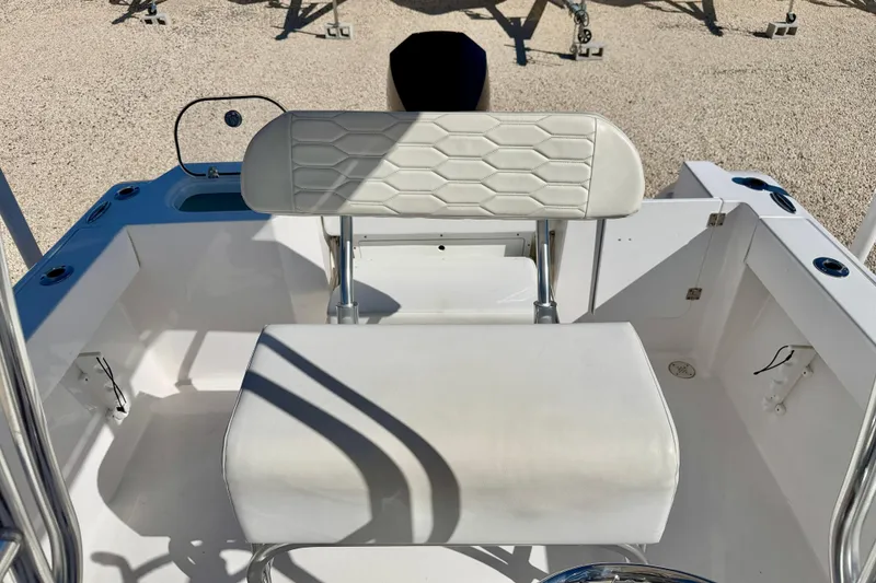 Slide: The Image of 2023 Aquasport 2200 Center Console boat interior with white seating and console. - 16