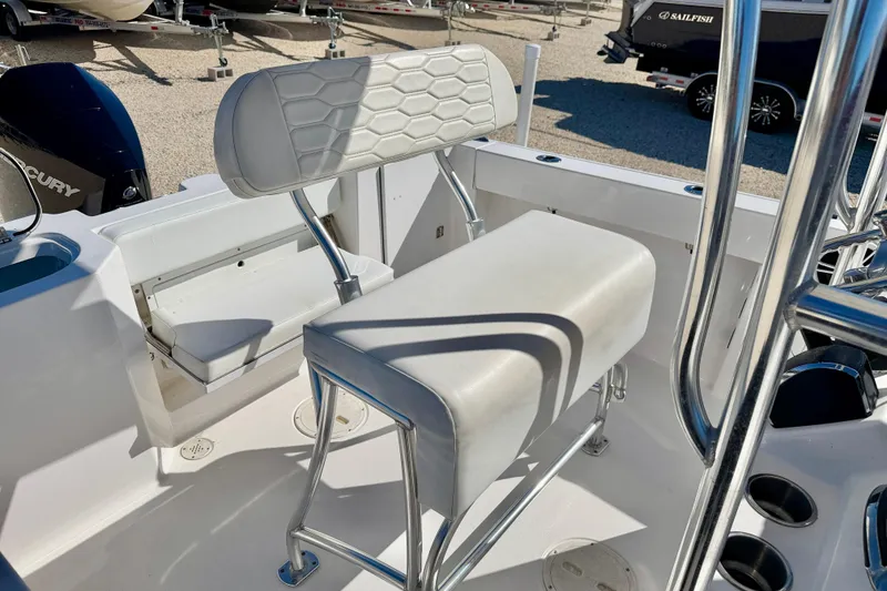 Slide: The Image of 2023 Aquasport 2200 Center Console boat interior with white seating and chrome details. - 17