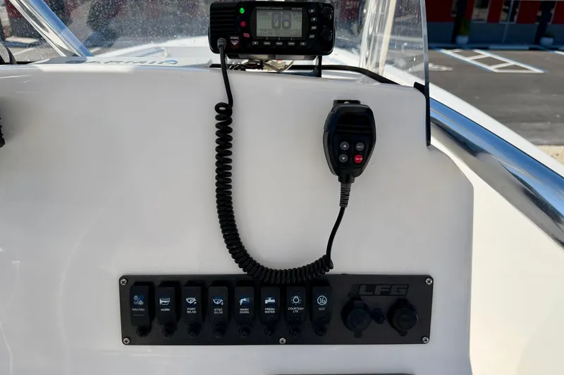 Slide: The Image of 2023 Aquasport 2200 Center Console dashboard with radio and control panel. - 23