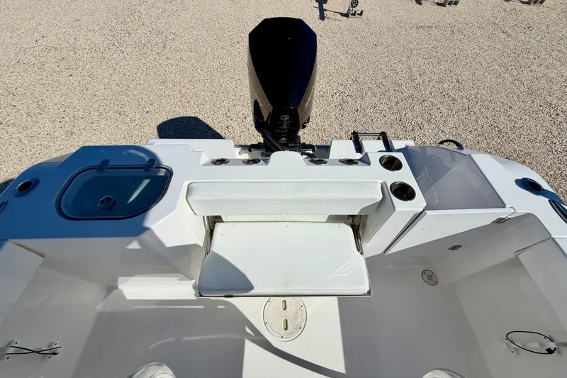 Slide: The Image of 2023 Aquasport 2200 Center Console boat interior with motor and seating area. - 24