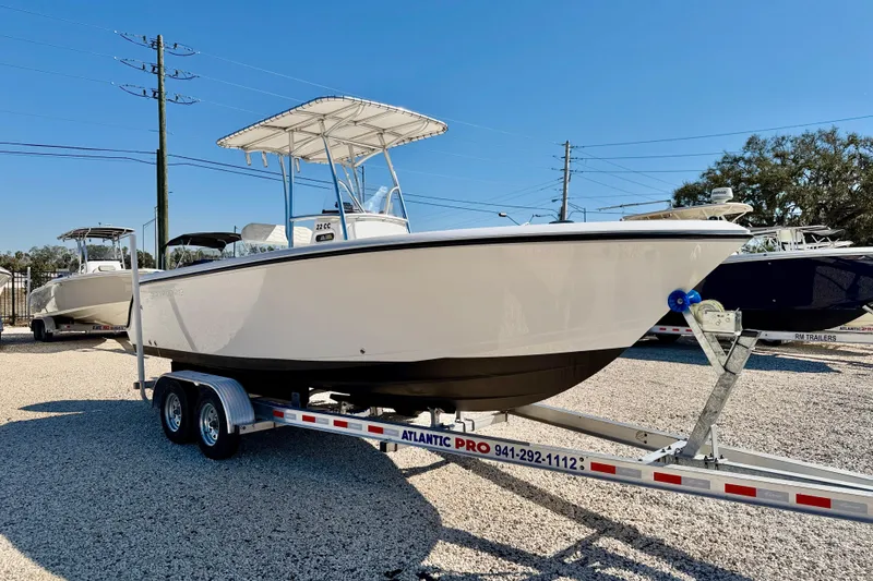 Slide: The Image of 2023 Aquasport 2200 Center Console boat on trailer, displayed outdoors. - 3