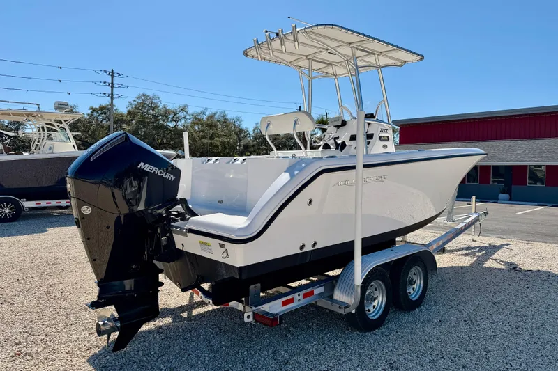 Slide: The Image of 2023 Aquasport 2200 Center Console boat on trailer, featuring Mercury outboard engine. - 5