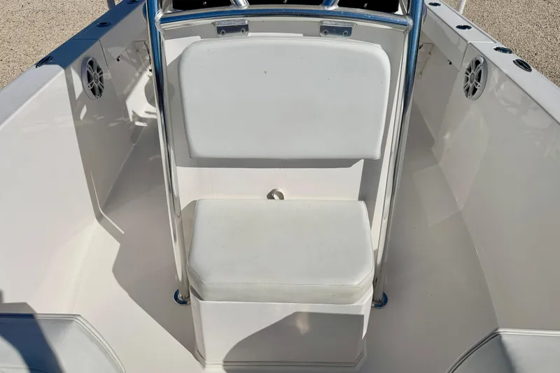 Slide: The Image of 2023 Aquasport 2200 Center Console boat interior with white seating and stainless steel frame. - 9