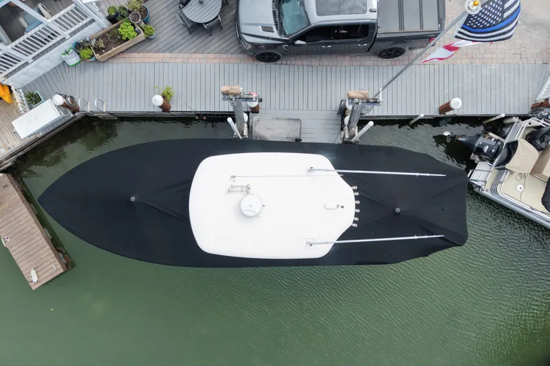 Slide: The Image of Overhead view of a 2015 Cobia 344 Center Console boat docked with cover. - 10
