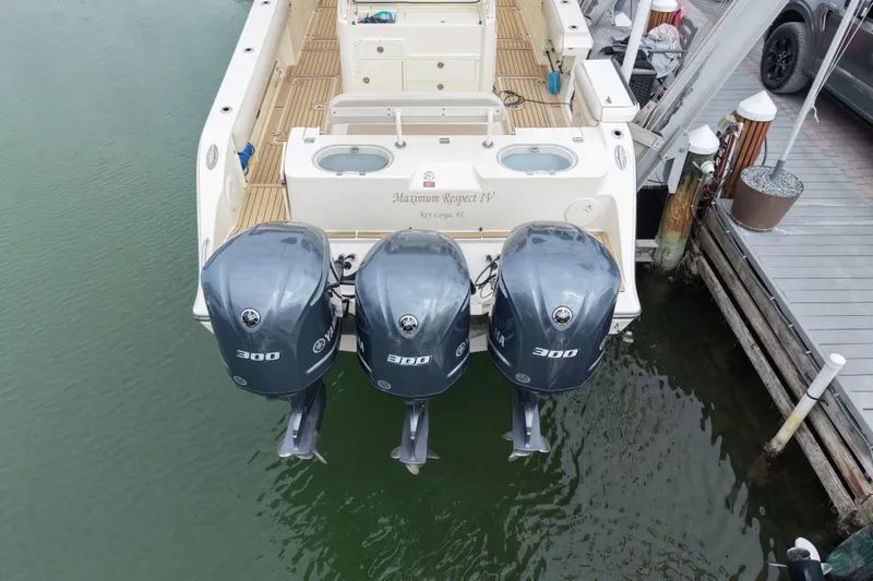 Slide: The Image of 2015 Cobia 344 Center Console with triple Yamaha 300 engines docked. - 14
