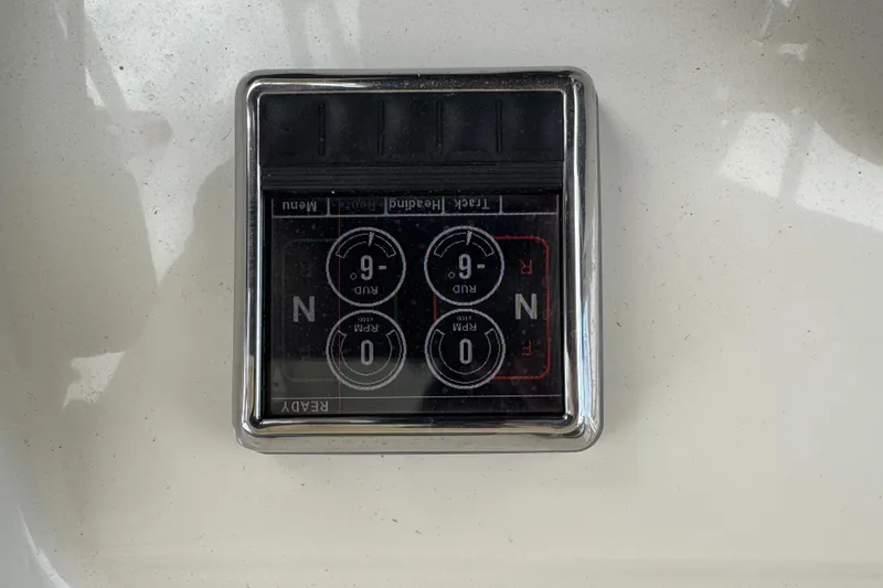 Slide: The Image of Control panel on 2015 Cobia 344 Center Console boat, displaying rudder and RPM settings. - 24