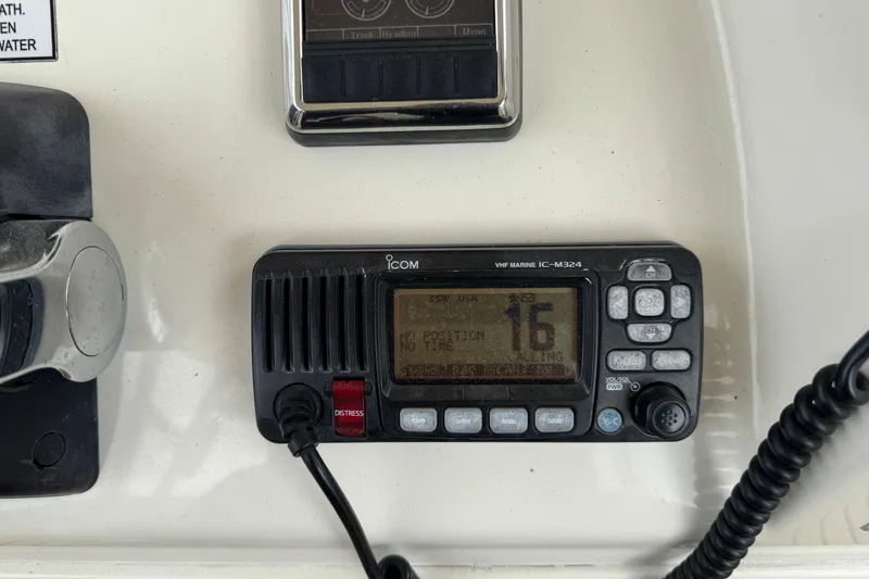 Slide: The Image of VHF marine radio on 2015 Cobia 344 Center Console boat dashboard. - 27