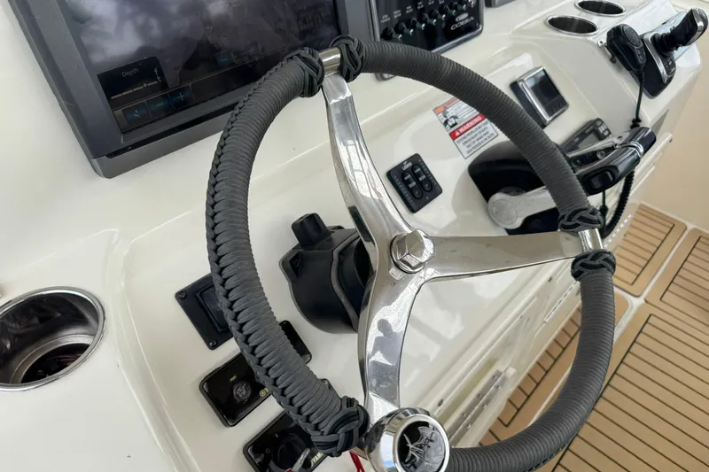 Slide: The Image of Steering wheel and controls of 2015 Cobia 344 Center Console boat. - 31
