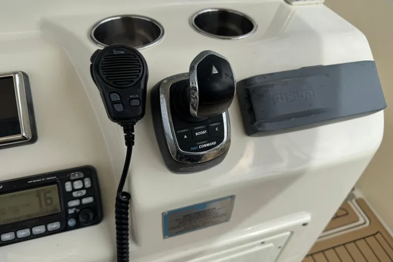 Slide: The Image of 2015 Cobia 344 Center Console boat controls with radio and throttle. - 35