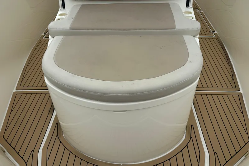 Slide: The Image of 2015 Cobia 344 Center Console boat seating with cushioned bench and teak-style flooring. - 38