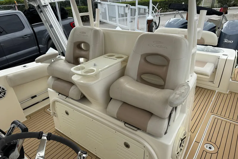 Slide: The Image of 2015 Cobia 344 Center Console boat with dual captain's chairs and teak flooring. - 41