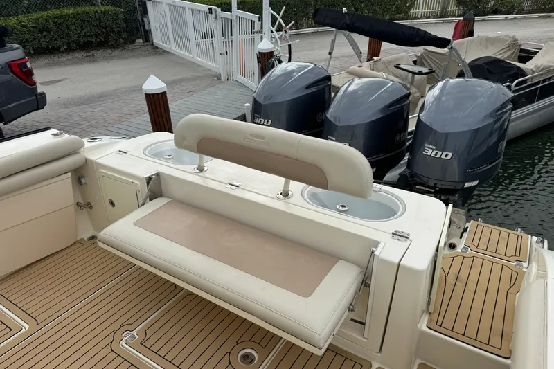 Slide: The Image of 2015 Cobia 344 Center Console boat with triple Yamaha 300 engines at dock. - 43