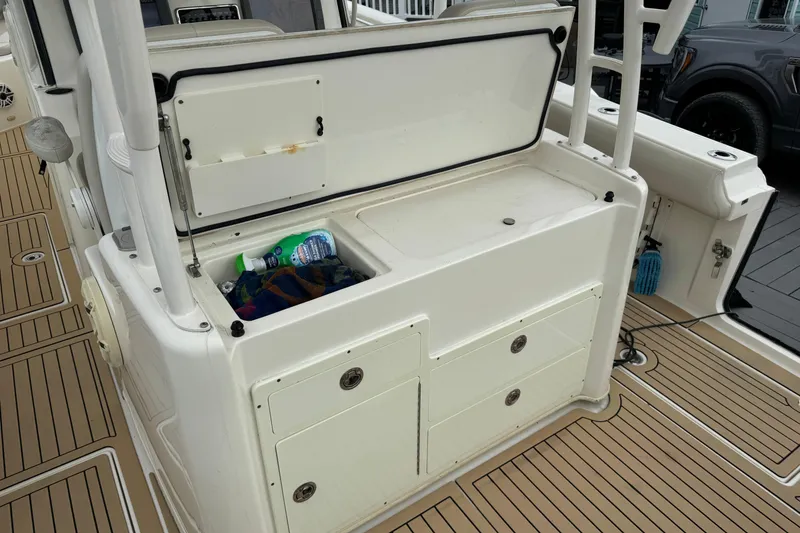 Slide: The Image of 2015 Cobia 344 Center Console boat interior with storage compartment open. - 44