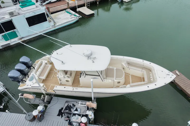 Slide: The Image of 2015 Cobia 344 Center Console boat docked in marina, aerial view. - 5