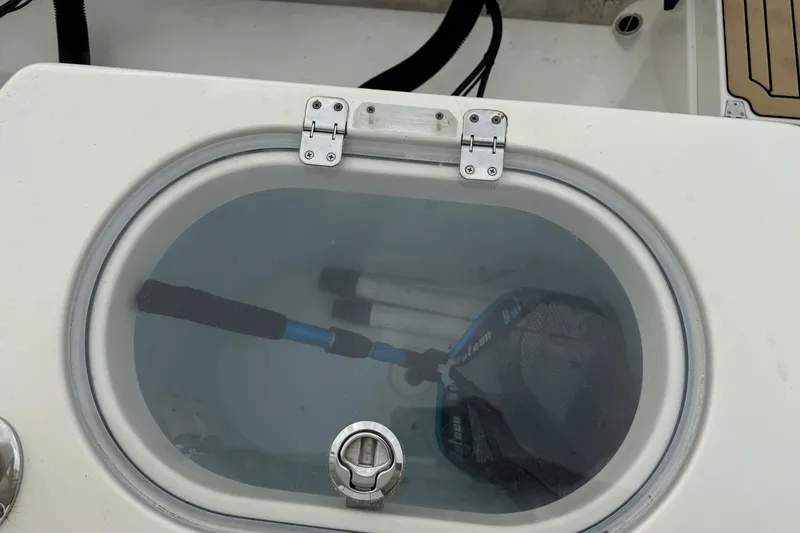 Slide: The Image of Livewell on 2015 Cobia 344 Center Console boat with fishing gear inside. - 50