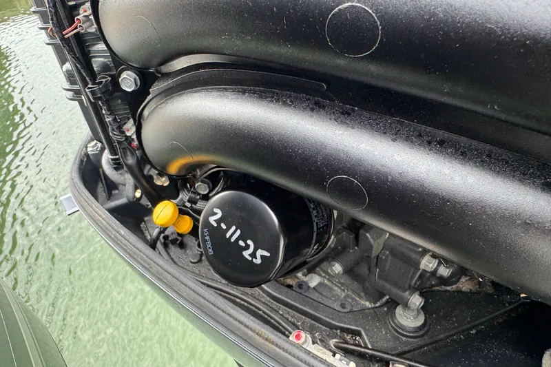 Slide: The Image of Engine detail of 2015 Cobia 344 Center Console boat near water. - 52