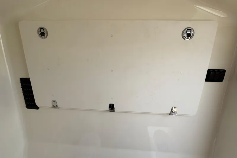 Slide: The Image of 2015 Cobia 344 Center Console storage compartment with secure latches and sleek design. - 54