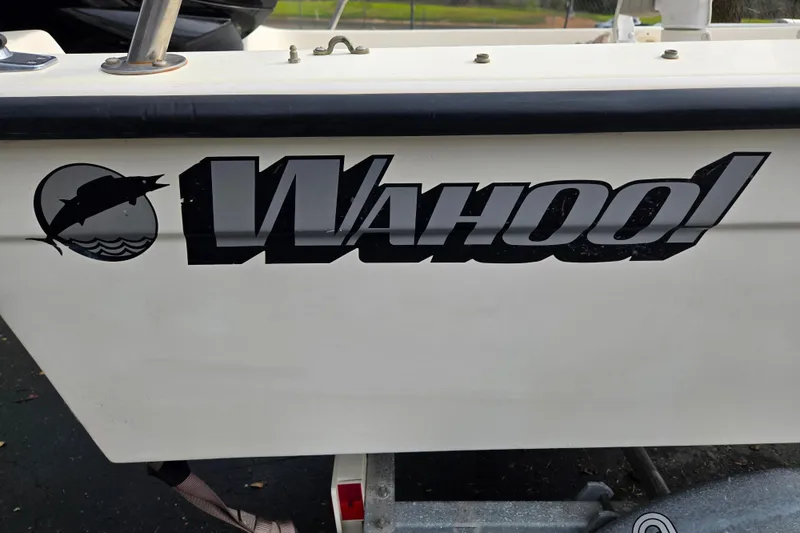 Slide: The Image of 1989 Wahoo 16.2 boat logo with fish graphic on white hull. - 14