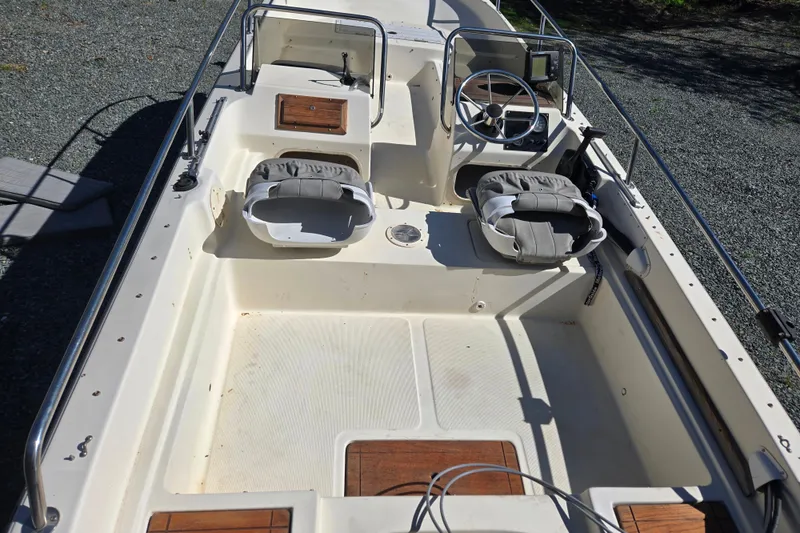 Slide: The Image of 1989 Wahoo 16.2 boat interior with dual seats and steering wheel. - 15