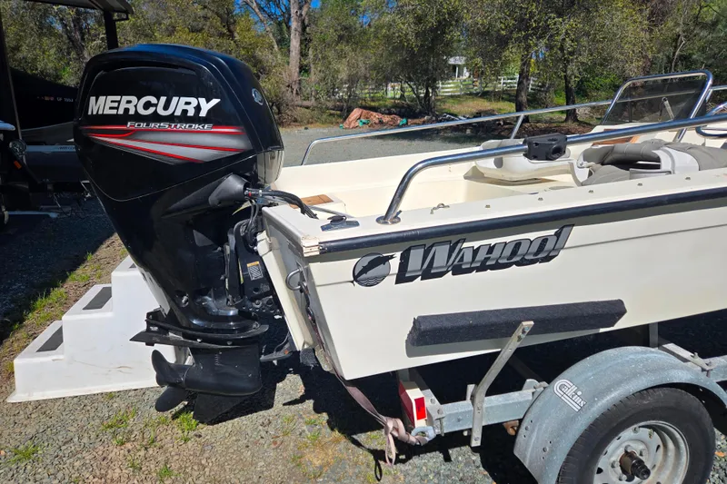 Slide: The Image of 1989 Wahoo 16.2 boat with Mercury FourStroke engine on a trailer. - 17