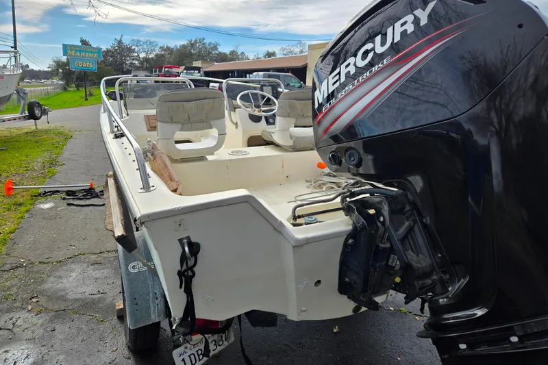 Slide: The Image of 1989 Wahoo 16.2 boat with Mercury outboard motor on a trailer. - 3
