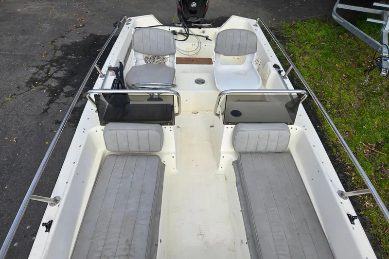 Slide: The Image of 1989 Wahoo 16.2 boat interior with gray seating and steering console. - 6