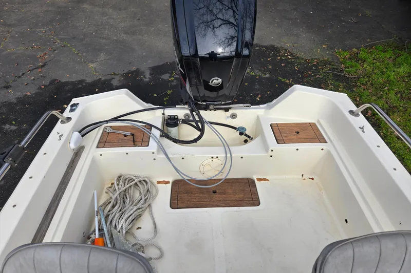 Slide: The Image of 1989 Wahoo 16.2 boat interior with motor, ropes, and storage compartments. - 7