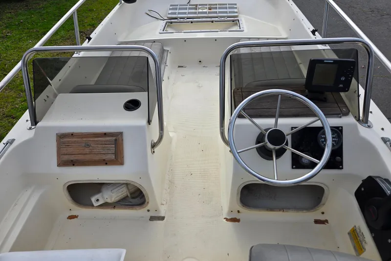 Slide: The Image of 1989 Wahoo 16.2 boat interior with steering wheel and navigation equipment. - 8