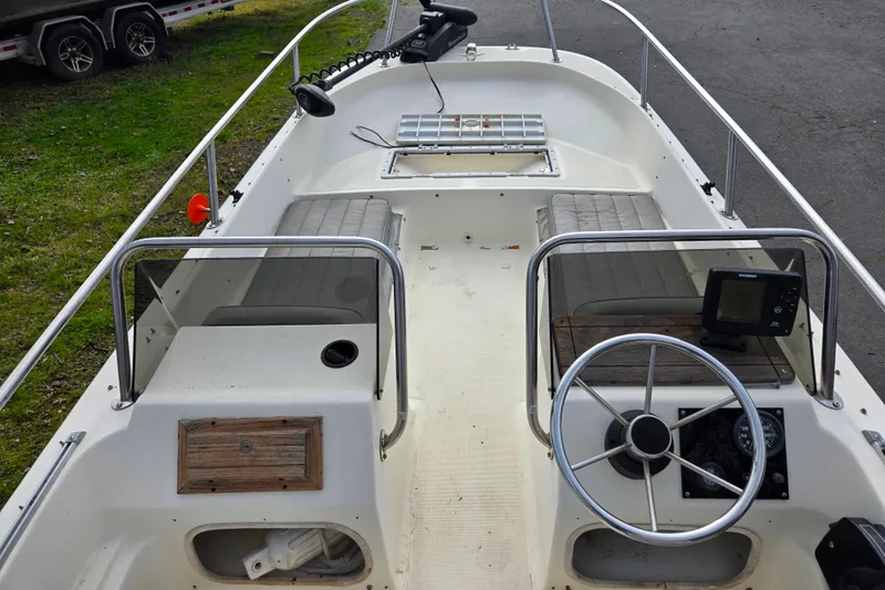 Slide: The Image of 1989 Wahoo 16.2 boat interior with steering wheel and seating. - 9