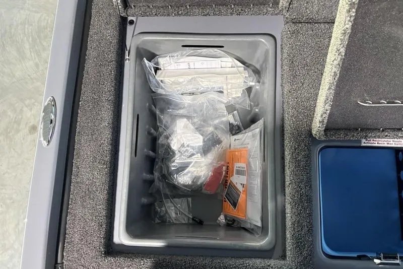 Slide: The Image of Interior storage compartment of 2026 Nitro Z19 Pro boat with various items. - 13