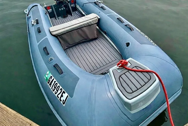 Slide: The Image of Blue inflatable boat docked with red rope, featuring a comfortable seating area. - 10