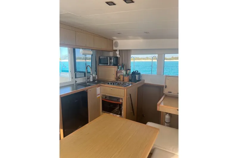 Slide: The Image of Interior of 2014 Lagoon 39 catamaran kitchen with ocean view through windows. - 12