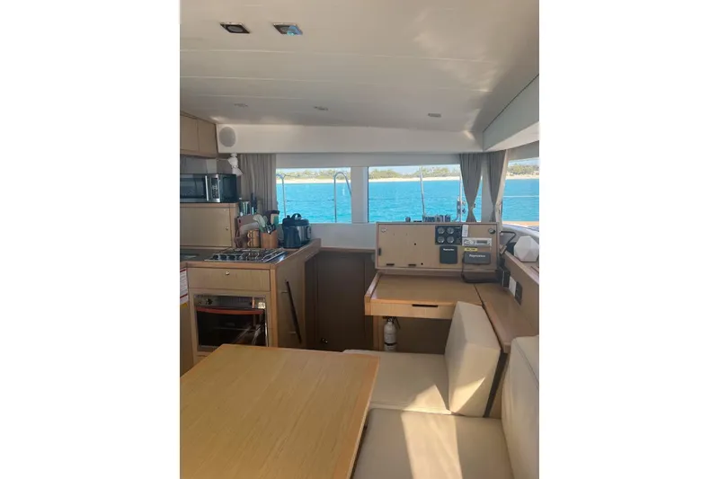 Slide: The Image of Interior of 2014 Lagoon 39 catamaran with kitchen and navigation area, overlooking the sea. - 13