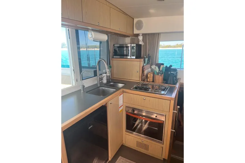 Slide: The Image of Interior of 2014 Lagoon 39 yacht kitchen with stove, sink, and ocean view. - 16