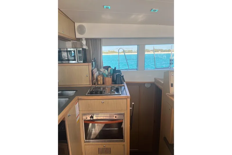 Slide: The Image of Interior of 2014 Lagoon 39 catamaran kitchen with ocean view through windows. - 17
