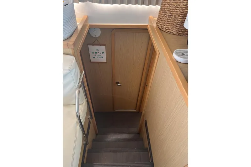 Slide: The Image of Interior stairs of 2014 Lagoon 39 yacht with wooden finish and decorative sign. - 20
