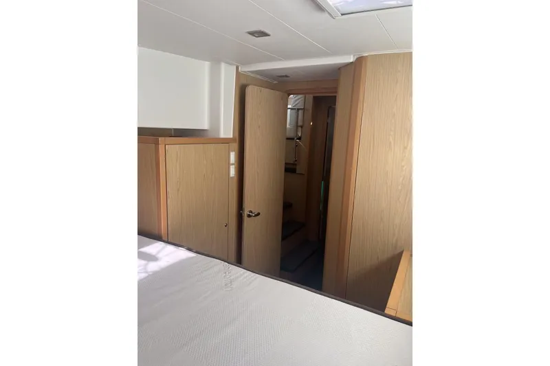 Slide: The Image of Interior of 2014 Lagoon 39 yacht, featuring wooden cabinetry and a cozy cabin space. - 23