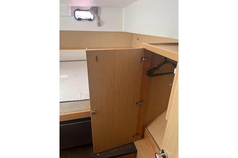 Slide: The Image of Interior cabin of 2014 Lagoon 39 yacht with open wooden closet. - 26