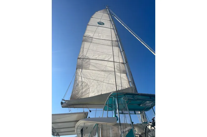 Slide: The Image of Sailing yacht Lagoon 39, 2014 model, with raised sails against a clear blue sky. - 7