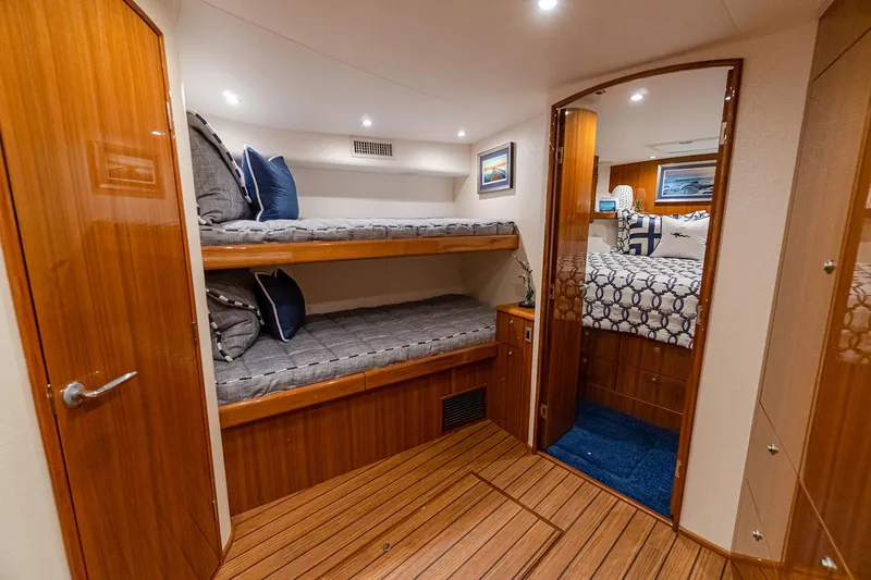 Slide: The Image of Manufacturer Provided Image: Interior of 2026 Viking 46 Billfish yacht with cozy bunk beds and elegant wood finish. - 12