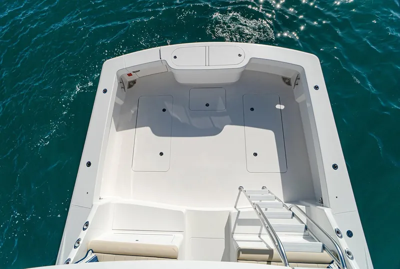 Slide: The Image of Manufacturer Provided Image: 2026 Viking 46 Billfish boat deck with ladder, surrounded by clear blue water. - 3