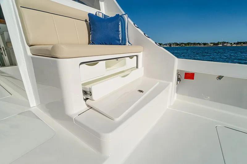 Slide: The Image of Manufacturer Provided Image: 2026 Viking 46 Billfish boat interior with cushioned seating and storage, overlooking the water. - 4