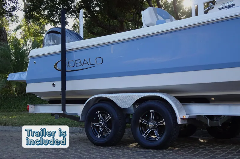 Slide: The Image of 2022 Robalo 246 Cayman boat on trailer, side view, with "Trailer is included" text. - 21